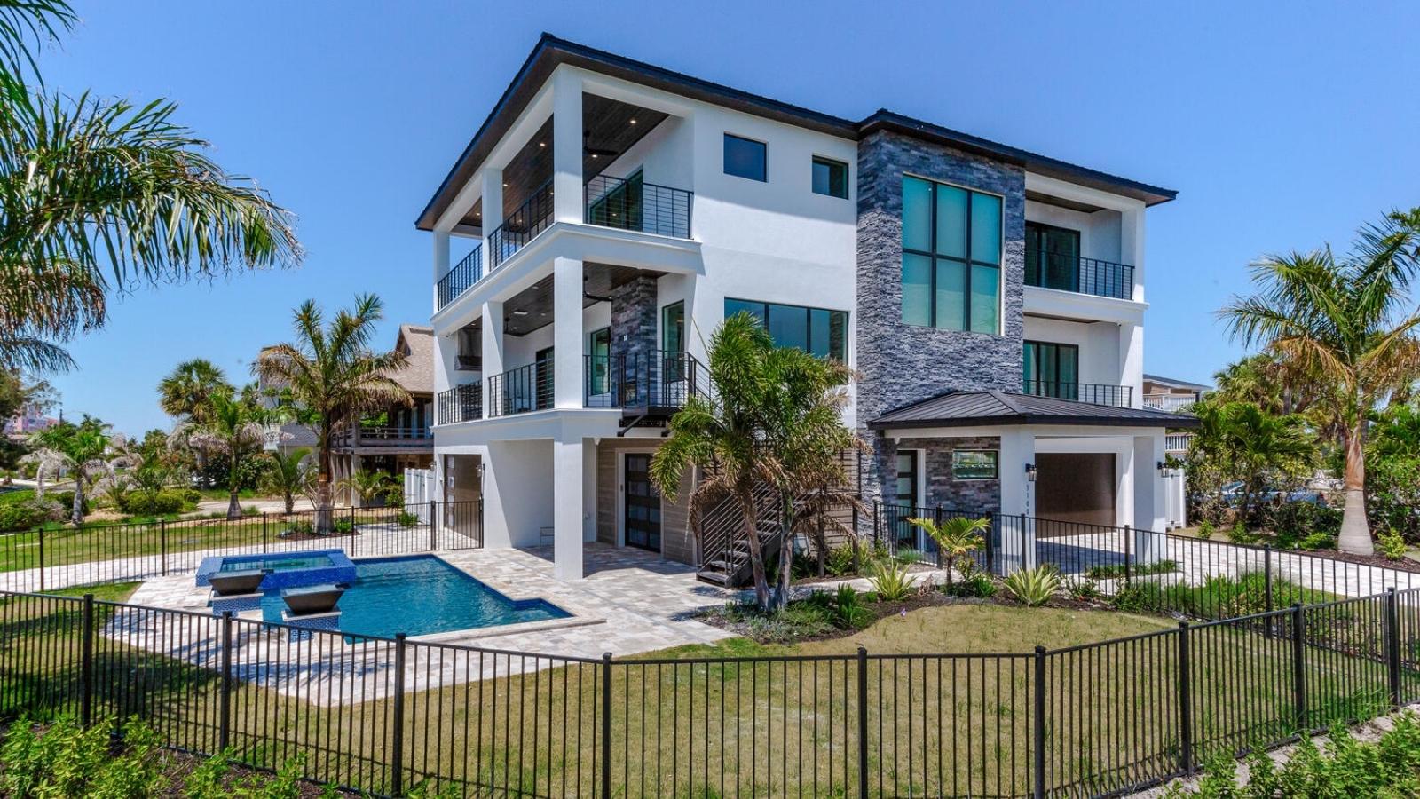 a luxury home with a pool in the front yard