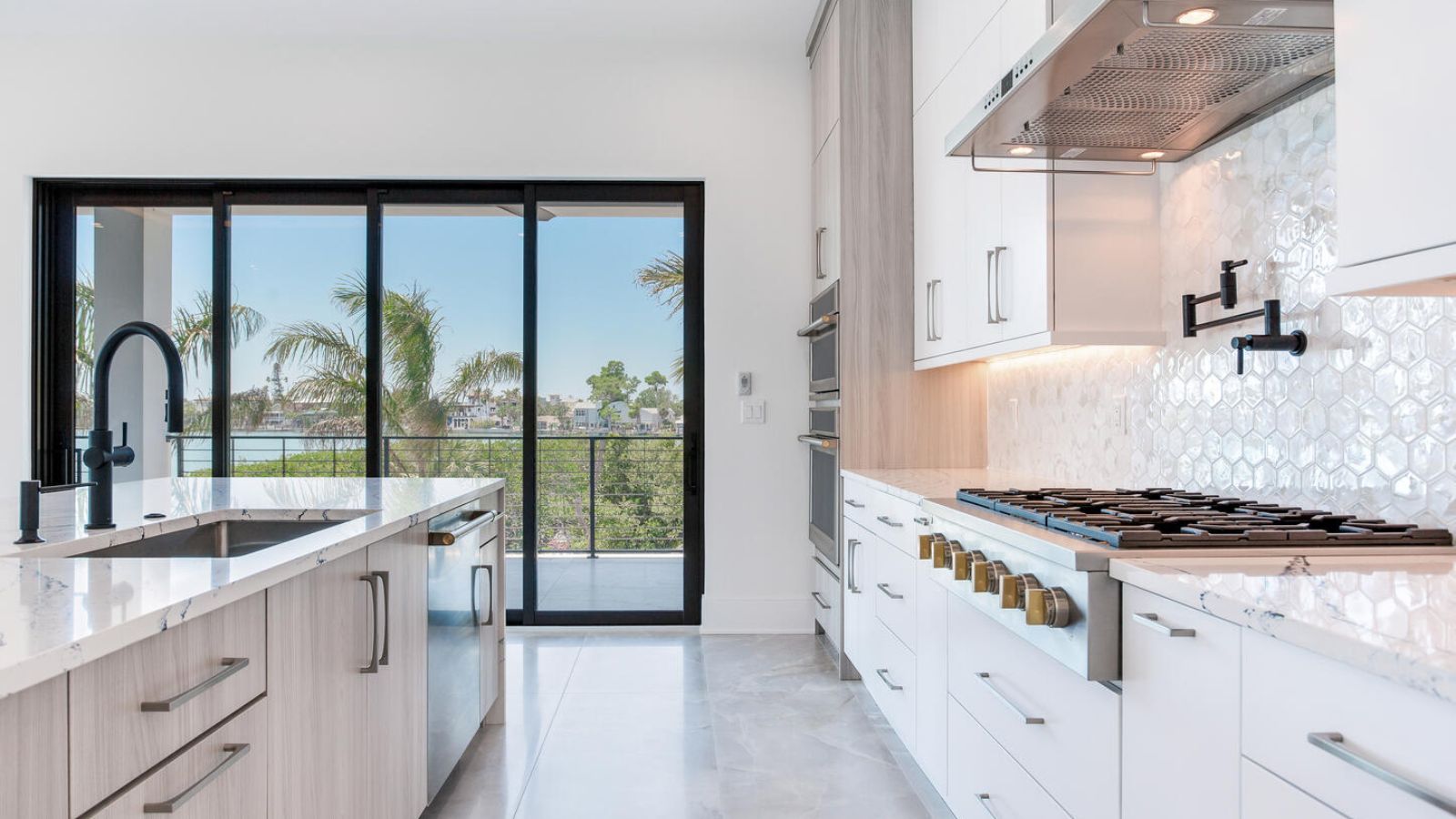 A modern kitchen with white cabinets and stainless steel appliances