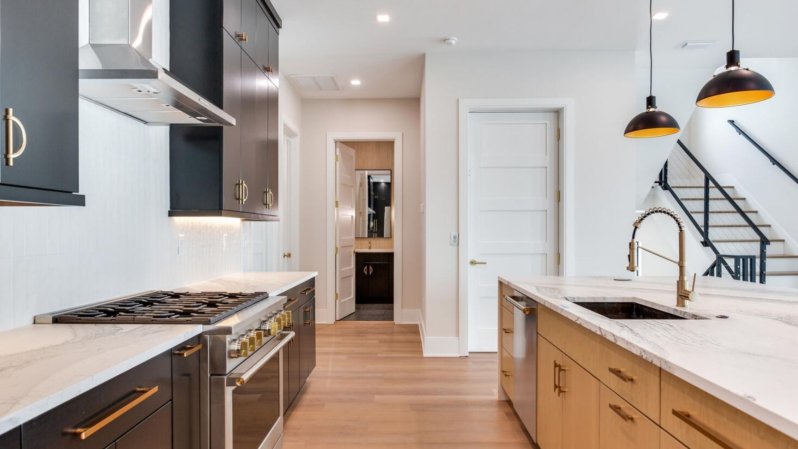 a kitchen with black cabinets and white counter tops