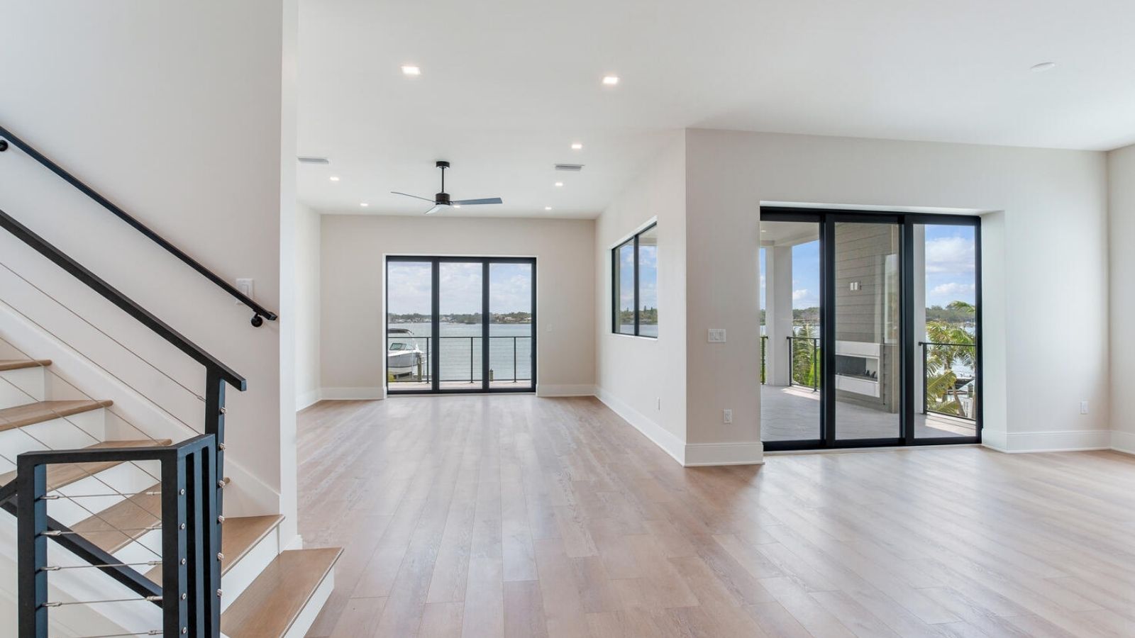 an empty living room with hardwood floors and white walls