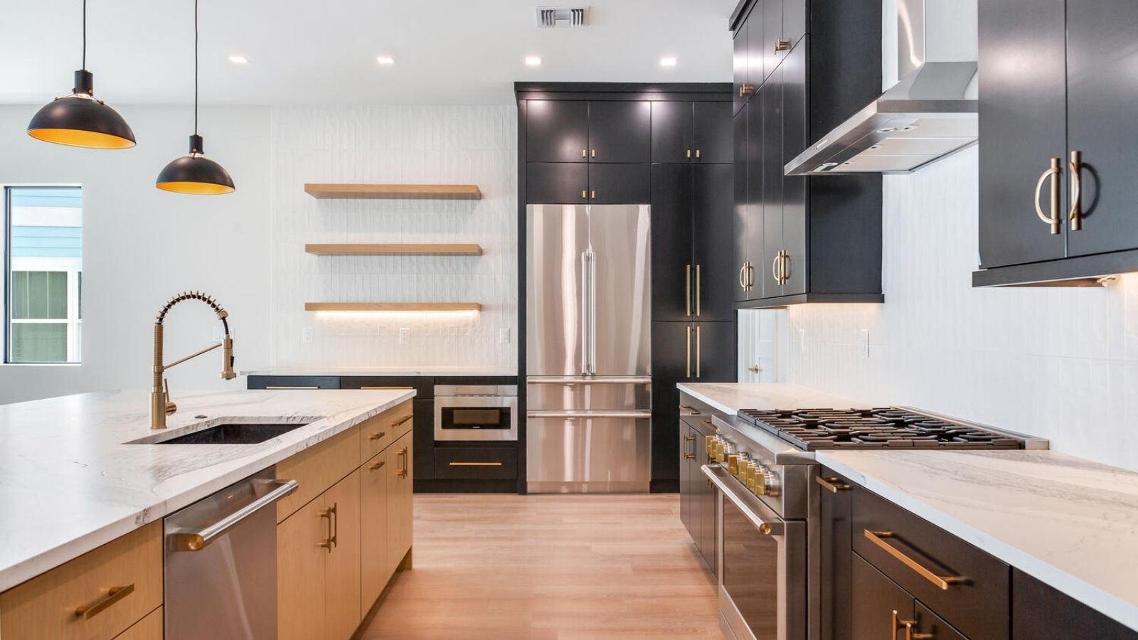 a modern kitchen with black cabinets and stainless steel appliances