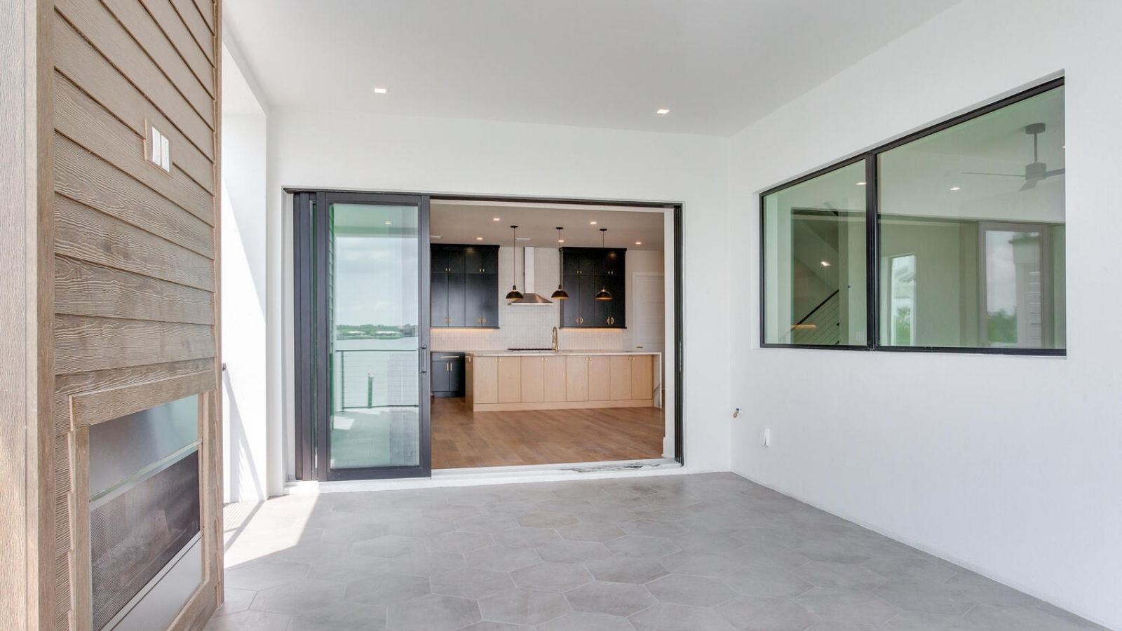 an open living room with a fireplace and sliding glass doors
