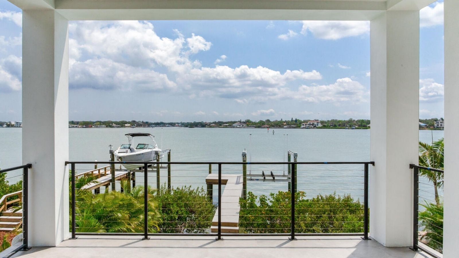 a balcony with a view of the water and a boat