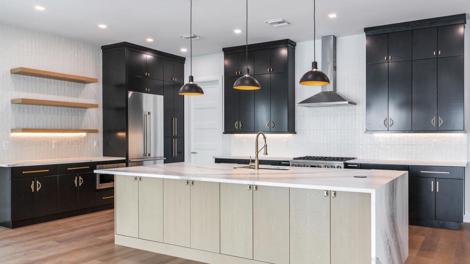 a modern kitchen with black cabinets and white counter tops