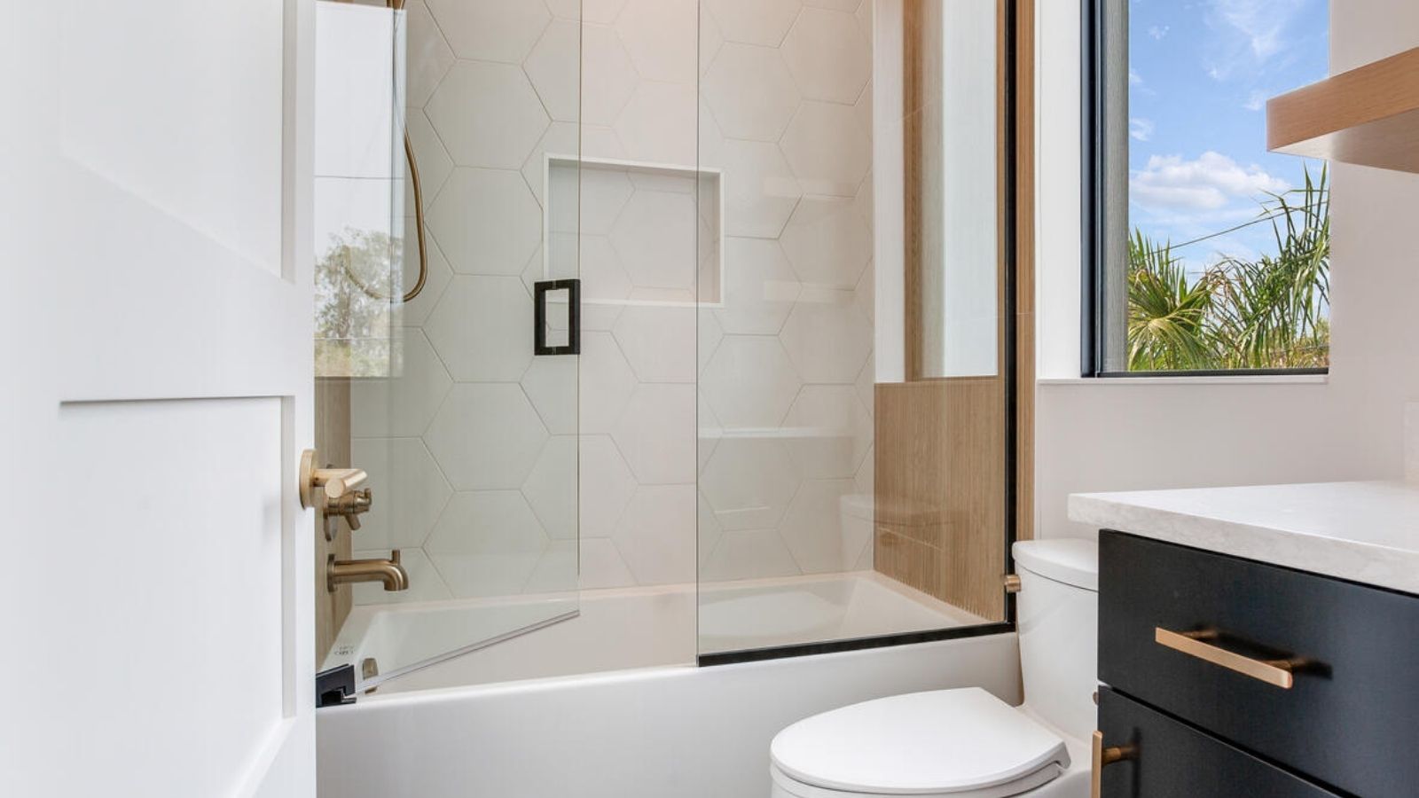 a modern bathroom with a glass shower door