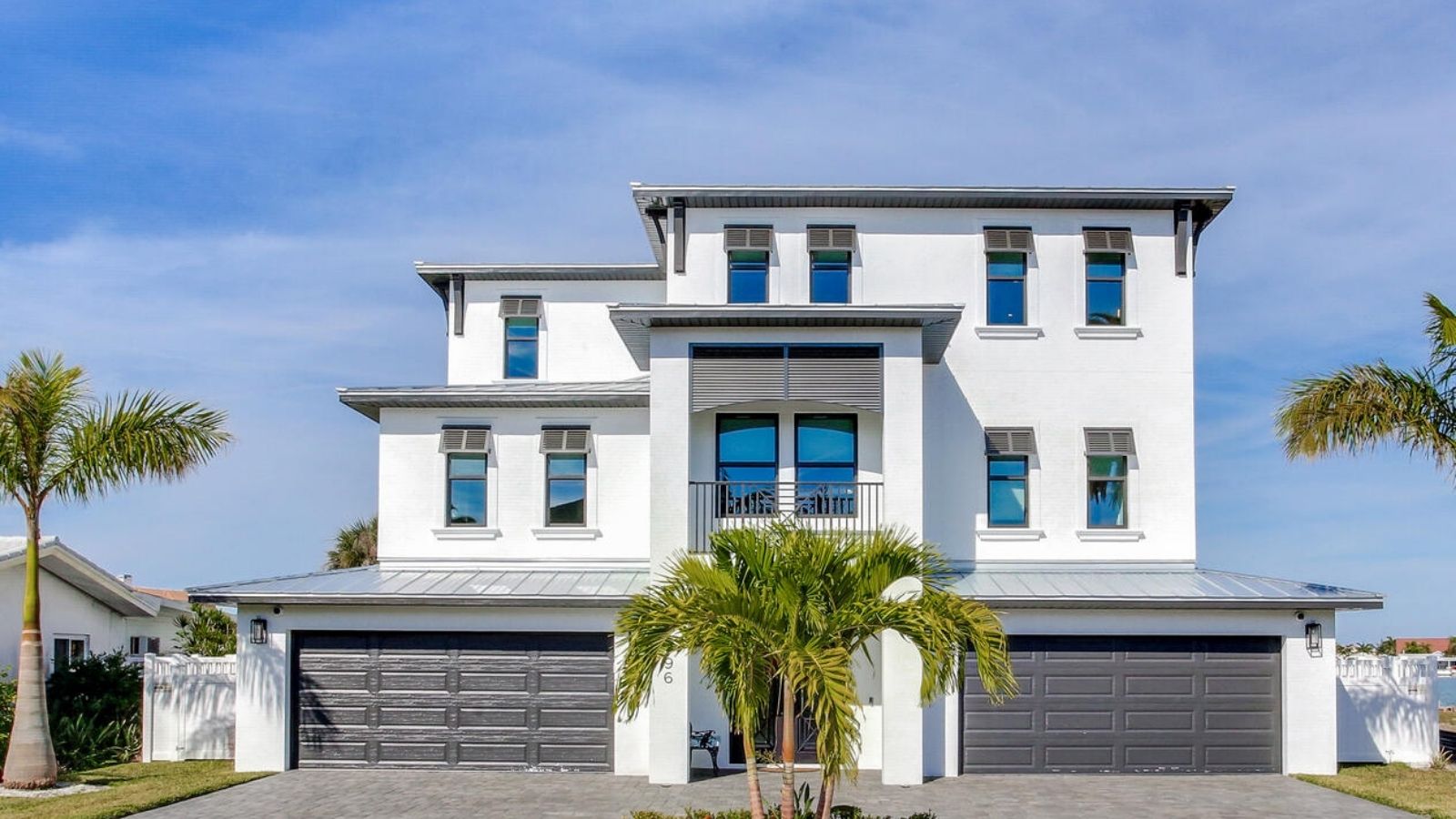 A home with palm trees in front of it