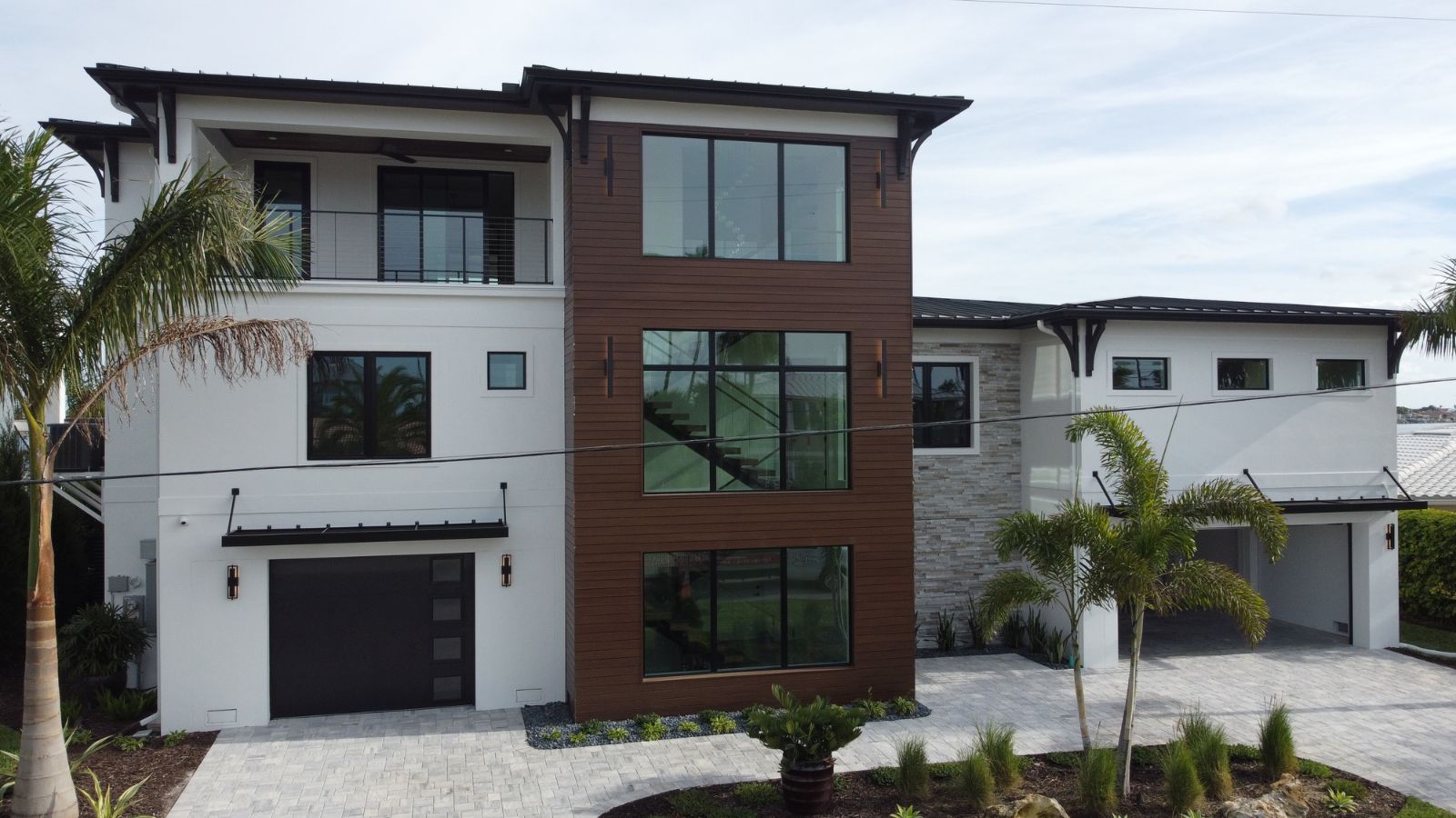 Modern waterfront custom home with metal roof and contemporary exterior design