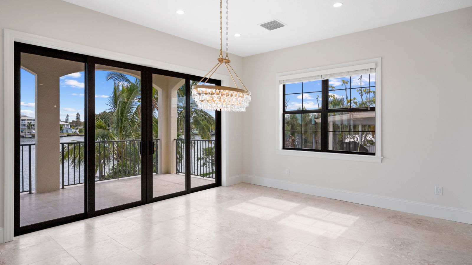 Airy open floor plan with large kitchen island, recessed lighting, and coastal-inspired finishes.