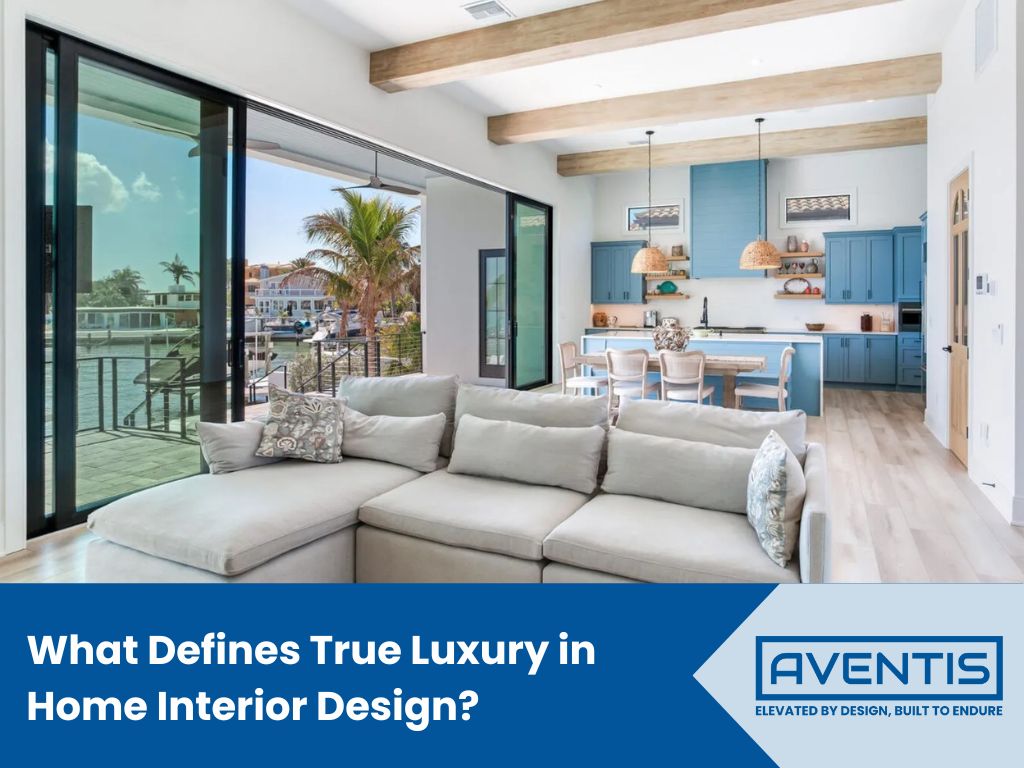 Luxury waterfront home interior with open living space, modern kitchen, and large glass doors overlooking the water.