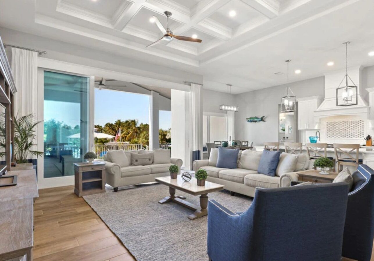 a large open living room with hardwood floors and a ceiling fan